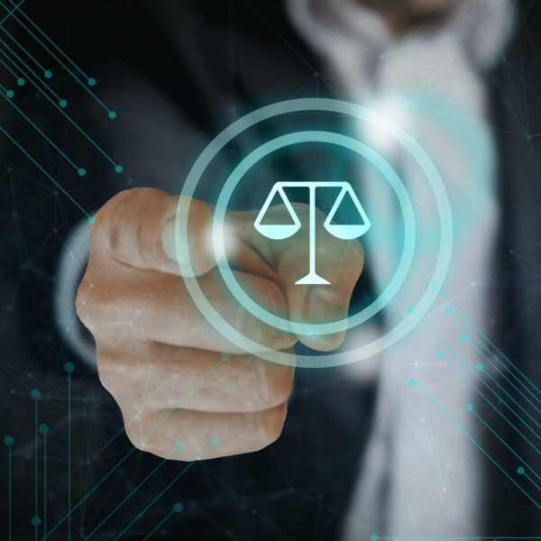 Ein Mann zeigt auf eine Waage, als Symbol für Gesetz